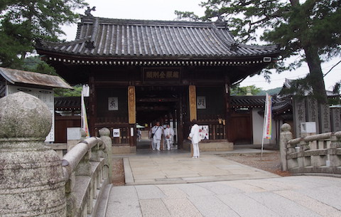 pilgrims in front of a temple entrance
